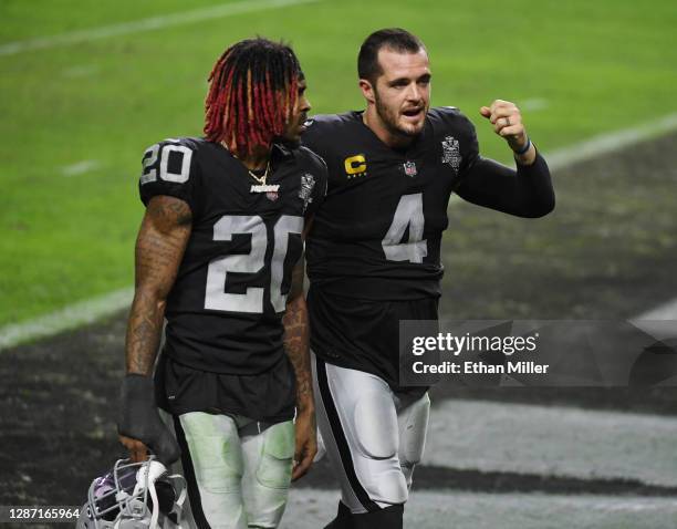 Cornerback Damon Arnette and quarterback Derek Carr of the Las Vegas Raiders walk off the field after their 35-31 loss to the Kansas City Chiefs at...