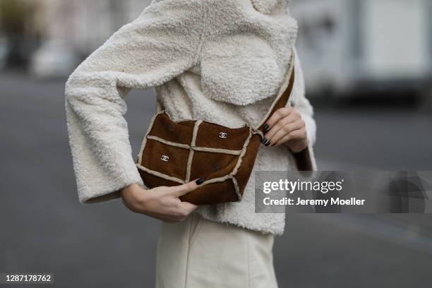 Celine Bethmann wearing a beige Weekday jacket, Chanel vintage brown bag, Zara mini skirt on November 21, 2020 in Berlin, Germany.