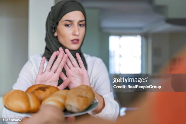 muslim woman refusing an unhealthy food - food staple stock pictures, royalty-free photos & images