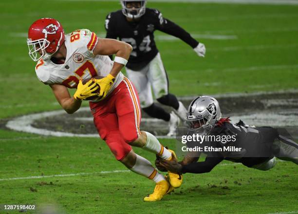 Tight end Travis Kelce of the Kansas City Chiefs avoids a tackle by cornerback Damon Arnette of the Las Vegas Raiders in the first half of their game...