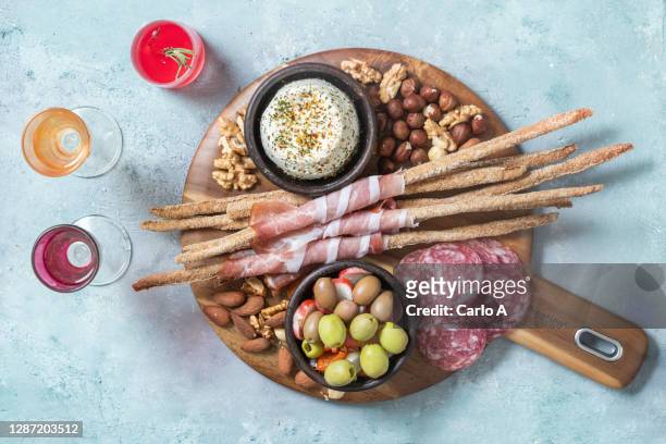 a platter with assorted appetizers, cheese, olives and cold cuts, dried fruit. - different cuts of meat stock pictures, royalty-free photos & images
