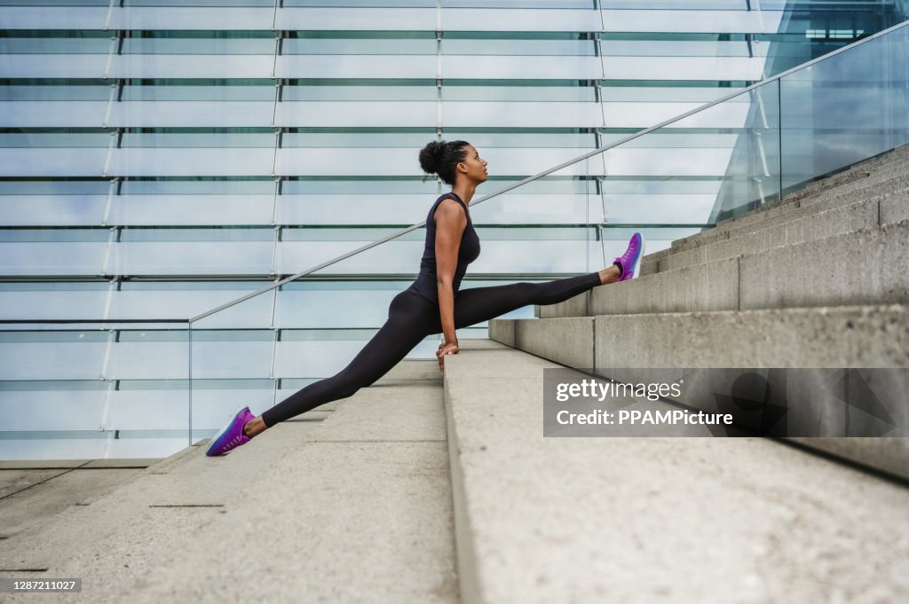 Woman doing splits on steps