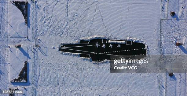 Aerial view of a Shandong aircraft carrier created by students and teachers from Harbin Engineering University on the snowfield as heavy snow hit...