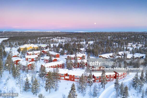 arctic sunrise on snowy forest and tourist resort huts, lapland - inari finland bildbanksfoton och bilder