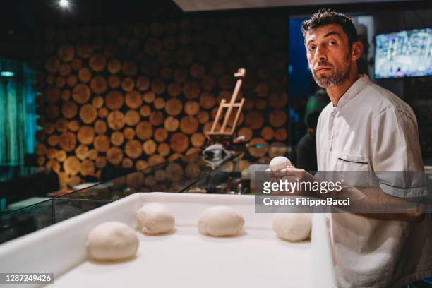 pizza chef preparing the pizza dough at the restaurant - pizza chef stock pictures, royalty-free photos & images