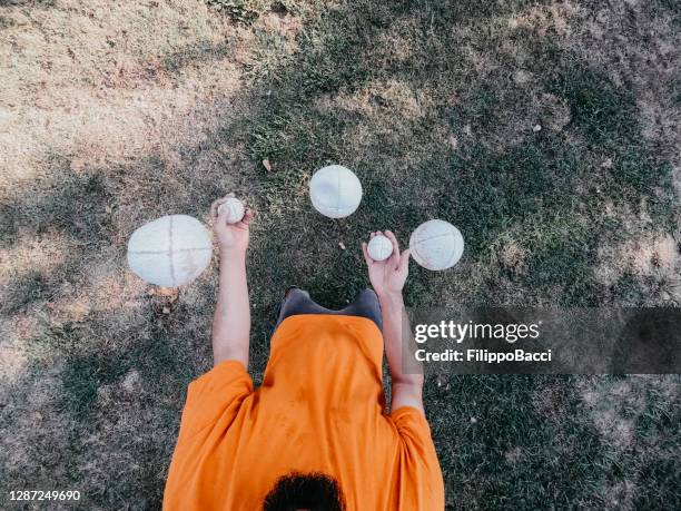 pov view of a juggler performing at the park - juggling stock pictures, royalty-free photos & images