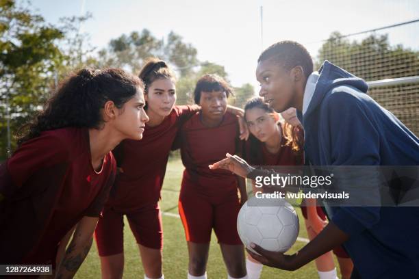 female soccer players listening to their coach before game - coach stock pictures, royalty-free photos & images