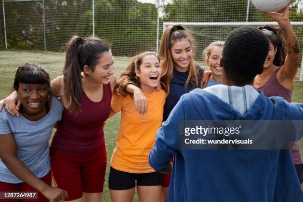 group of female soccer players celebrating scored goal with coach - soccer team coach stock pictures, royalty-free photos & images