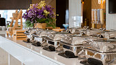 heating trays on buffet line ready for service. breakfast and lunch buffet food catering banquet in hotel or restaurant.
