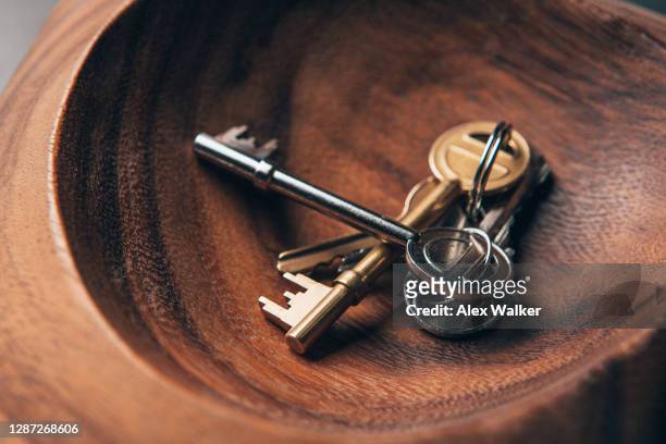 assorted keys in wooden bowl - locksmith stock pictures, royalty-free photos & images