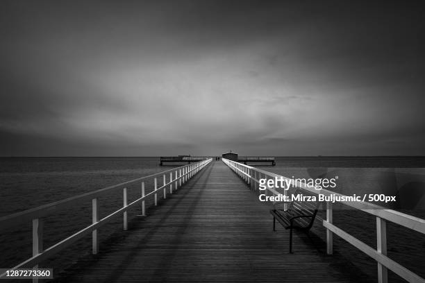 empty pier over sea against sky,sweden - length stock pictures, royalty-free photos & images