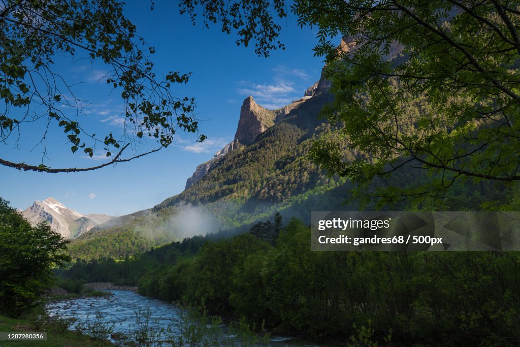 Scenic view of river amidst trees against sky,Monte Perdido,Spain