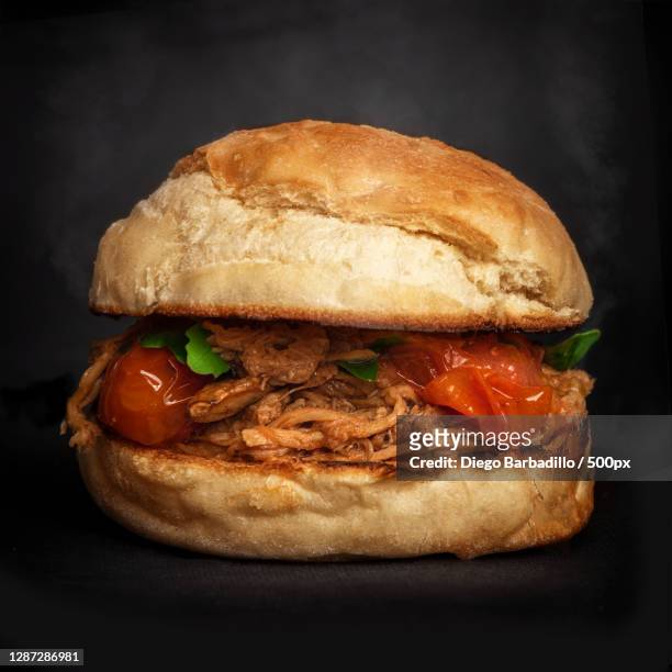 close-up of burger on black background,valencia,spain - hamburguesa stock-fotos und bilder