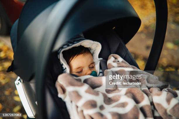 little baby boy sleeping in the stroller - carriage stock pictures, royalty-free photos & images