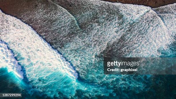 drone view of the ocean waves - slow motion water stock pictures, royalty-free photos & images