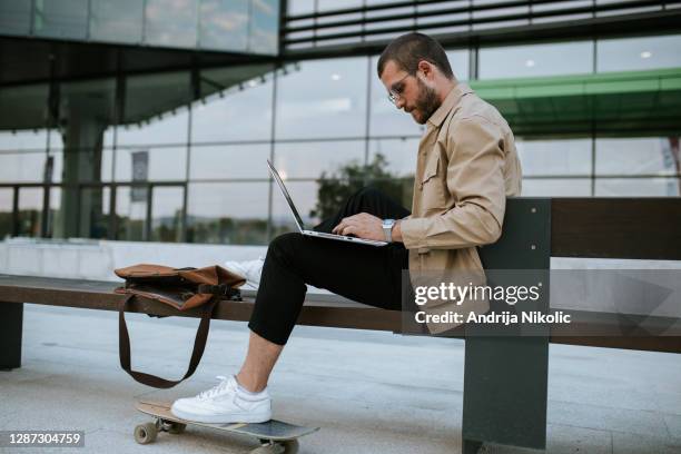 modern ceo working on a lap top outside. - modern malta stock pictures, royalty-free photos & images