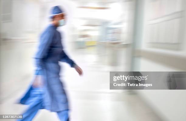 doctor running in hospital - operating gown stock pictures, royalty-free photos & images