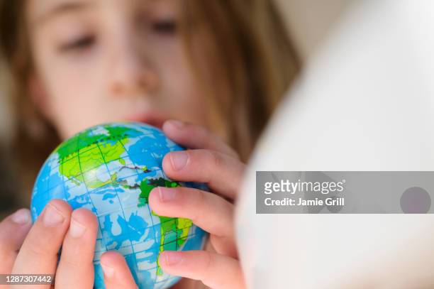 girl (6-7) holding globe - world children day stock pictures, royalty-free photos & images