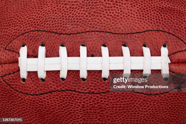 close up of laces on american football ball - cordon photos et images de collection