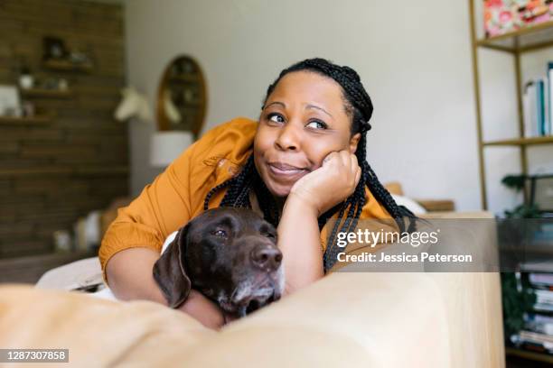 woman lying on sofa with her dog - german shorthaired pointer stock pictures, royalty-free photos & images