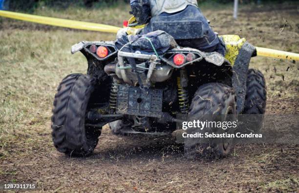 off-road vehicle catches air in a heavily wooded area. - quadbike stock pictures, royalty-free photos & images