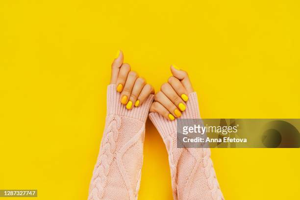 woman in sweater with colorful manicure. trending bright backdrop of the year. perfect nails concept - top garment stock pictures, royalty-free photos & images
