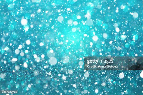 abstract background made with illuminating glittering sparkles. new year coming concept. - teal bokeh stock pictures, royalty-free photos & images