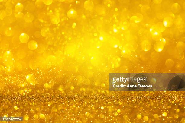 abstract background made with illuminating glittering sparkles. new year coming concept. - christmas background abstract gold stock pictures, royalty-free photos & images