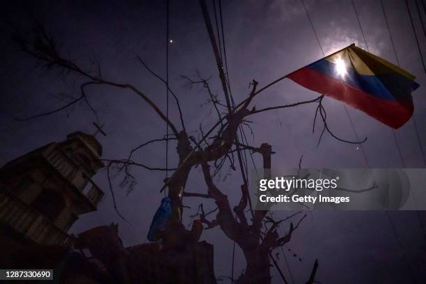 Colombian flag hangs on a tree near a chruch on November 22, 2020 in Providencia Island, Colombia. The islands of San Andres, Providencia and Santa...