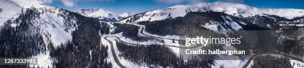 winding road in rocky mountains in winter - aerial panorama - colorado mountain road stock pictures, royalty-free photos & images