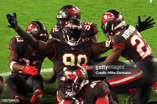 Jason Pierre-Paul of the Tampa Bay Buccaneers celebrates with his teammates after intercepting a pass thrown by Jared Goff of the Los Angeles Rams...