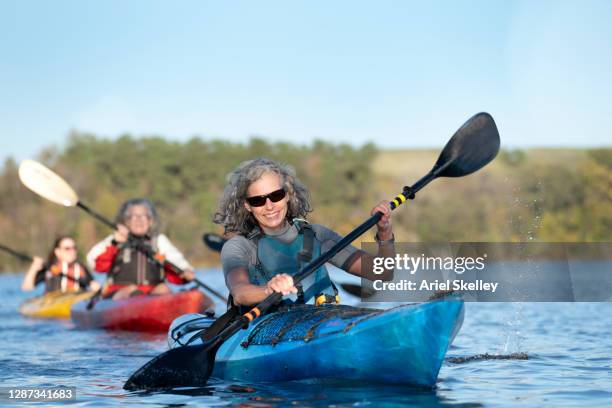 group of senior friends kayaking - seniors canoeing stock pictures, royalty-free photos & images
