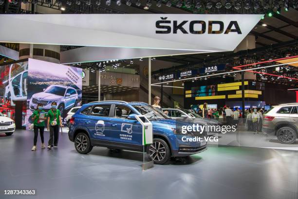 People visit the Skoda booth during the 18th Guangzhou International Automobile Exhibition at China Import and Export Fair Complex on November 23,...