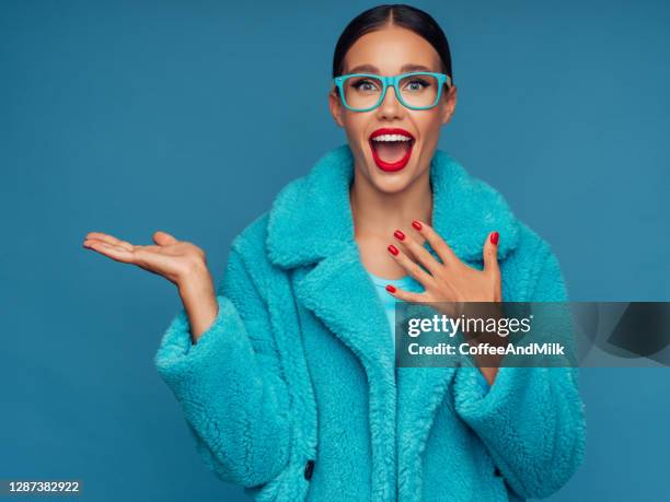 glimlachende mooie vrouw die uw product presenteert - fur coat stockfoto's en -beelden