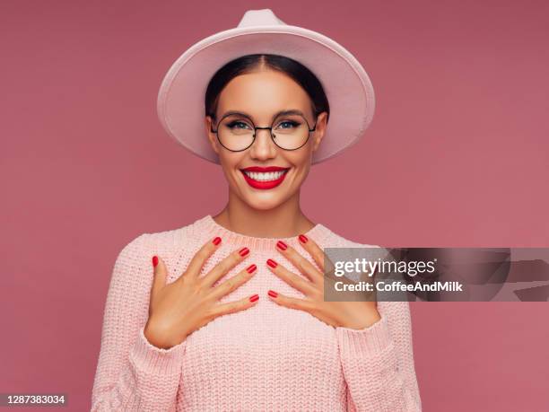 beautiful woman wearing pink hat - red eyeglasses stock pictures, royalty-free photos & images