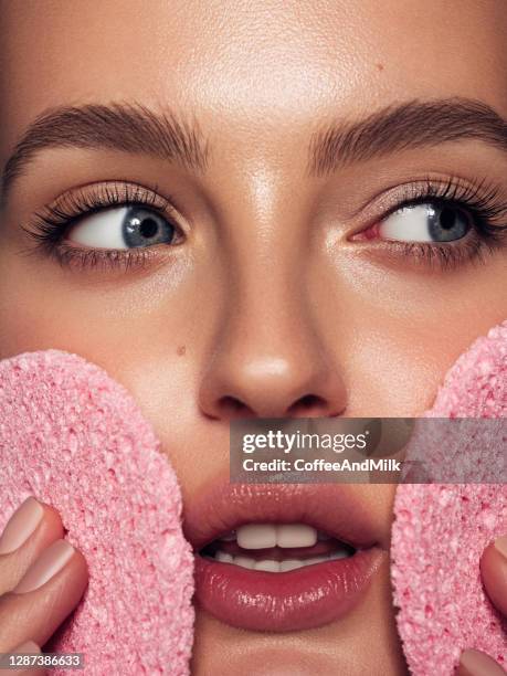 young woman cleans the skin natural sponge - clean beauty stock pictures, royalty-free photos & images