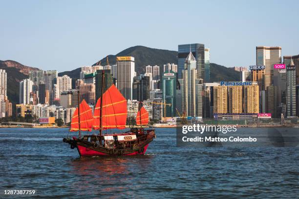 junk sail in victoria harbour, hong kong, china - wooden boat stock pictures, royalty-free photos & images