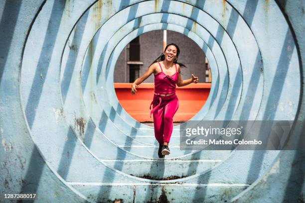 woman running through circle shaped structure, hong kong - travel arrangement stock pictures, royalty-free photos & images