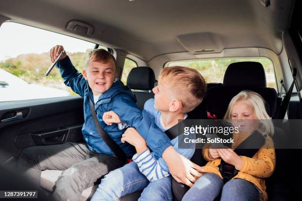 give me the phone back! - sibling kids stock pictures, royalty-free photos & images