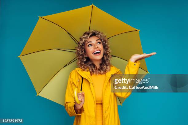 girl with yellow umbrella - girl shower stock pictures, royalty-free photos & images