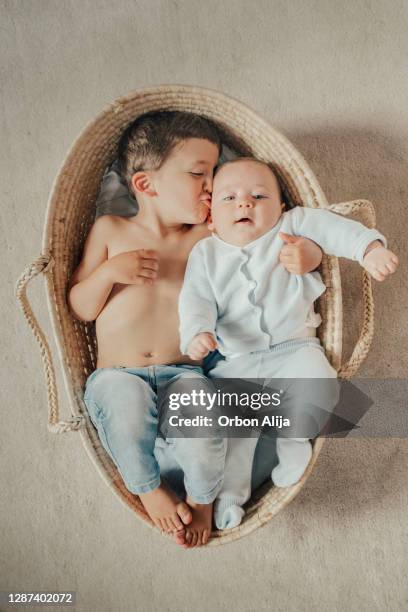 brothers inside a basket - lying on back stock pictures, royalty-free photos & images