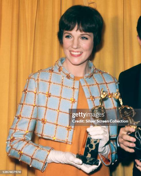 English actress and singer Julie Andrews at the 25th Golden Globe Awards, USA, 12th February 1968. She is holding her award for World Film Favorite .