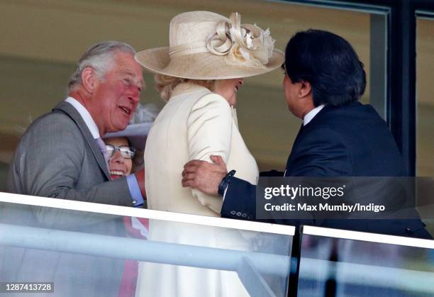 Prince Charles, Prince of Wales looks on as Sanjeev Bhaskar greets Camilla, Duchess of Cornwall on day 1 of Royal Ascot at Ascot Racecourse on June...