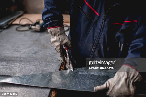 close up off man in factory workshop working - sheet metal stock pictures, royalty-free photos & images