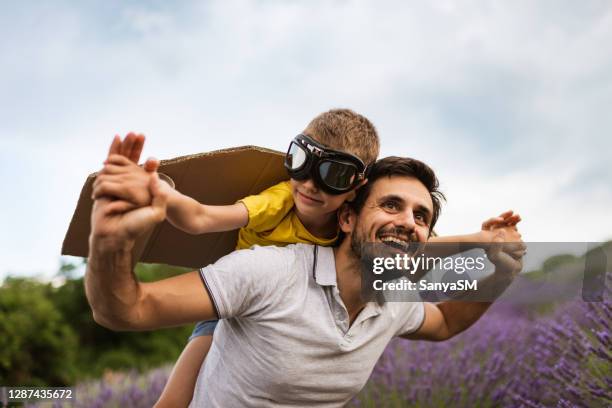 father and son enjoying on lavender field - kid day dreaming stock pictures, royalty-free photos & images