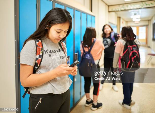 checking her messages before class - 12 year old indian girl stock pictures, royalty-free photos & images