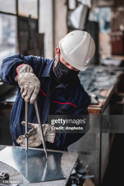 mature man in factory workshop working alone during epidemic - sheet metal worker stock pictures, royalty-free photos & images