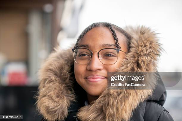 preteen girl outside in the city in the winter - displaced stock pictures, royalty-free photos & images