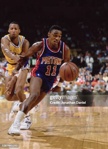 Isiah Thomas, Point Guard for the Detroit Pistons dribbles the basketball past Byron Scott of the Los Angeles Lakers during the NBA Pacific Division...