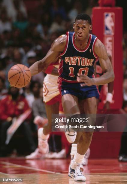 Dennis Rodman, Power Forward for the Detroit Pistons dribbles the basketball up court during the NBA Central Division basketball game against the...